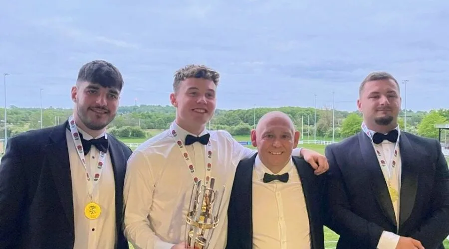 Max Thatcher, Ewan Laughton, Flip Nawrocki with Leeds Tykes Director of Rugby Pete Seabourne and their Nat2N champions medals and cup