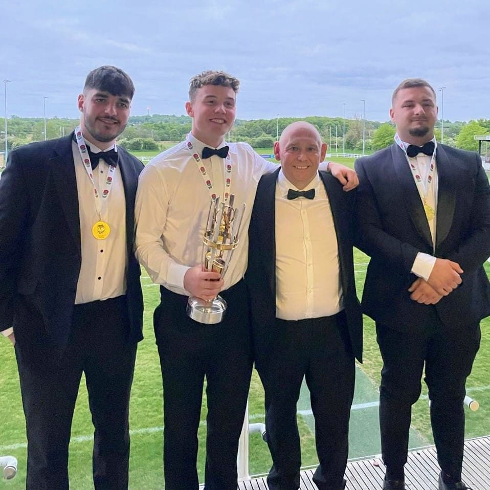 Max Thatcher, Ewan Laughton, Flip Nawrocki with Leeds Tykes Director of Rugby Pete Seabourne and their Nat2N champions medals and cup
