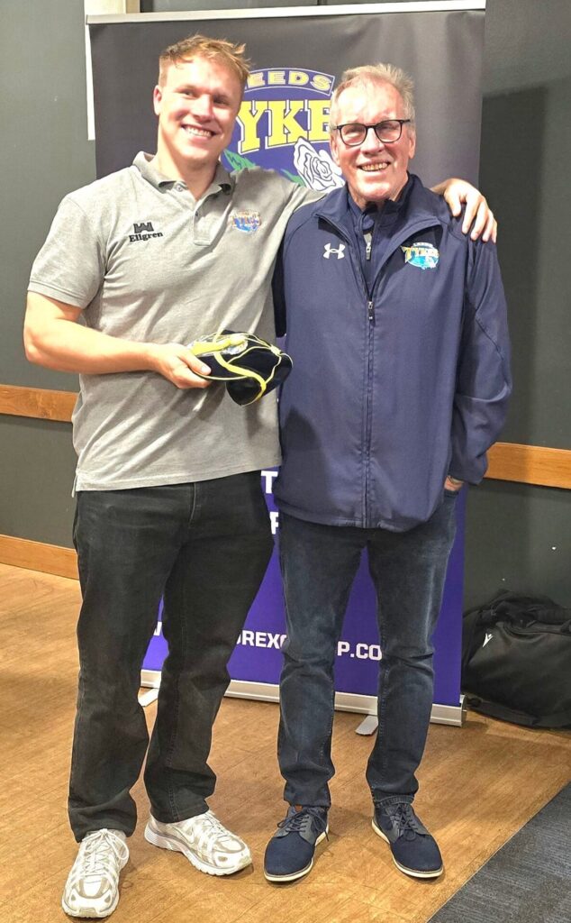 Tom Williams being presented with his 100th appearance club cap by his father John.