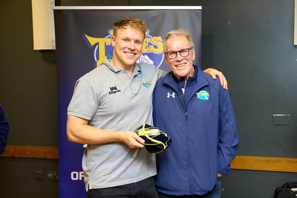 Tom Williams being presented with his 100th appearance club cap by his father John.